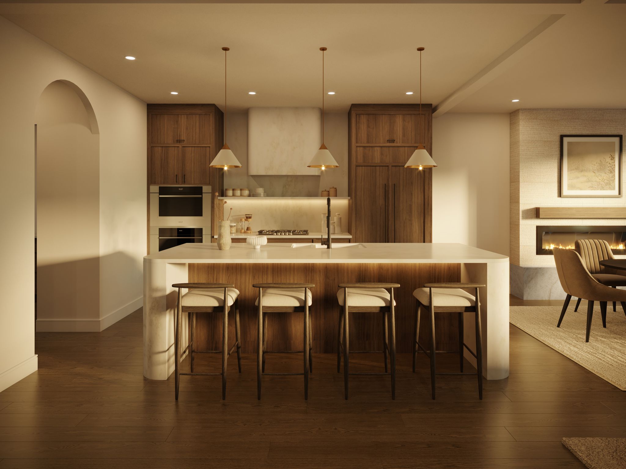 A modern kitchen with a large island and bar stools, wood cabinets, and a view of a living area with a fireplace.